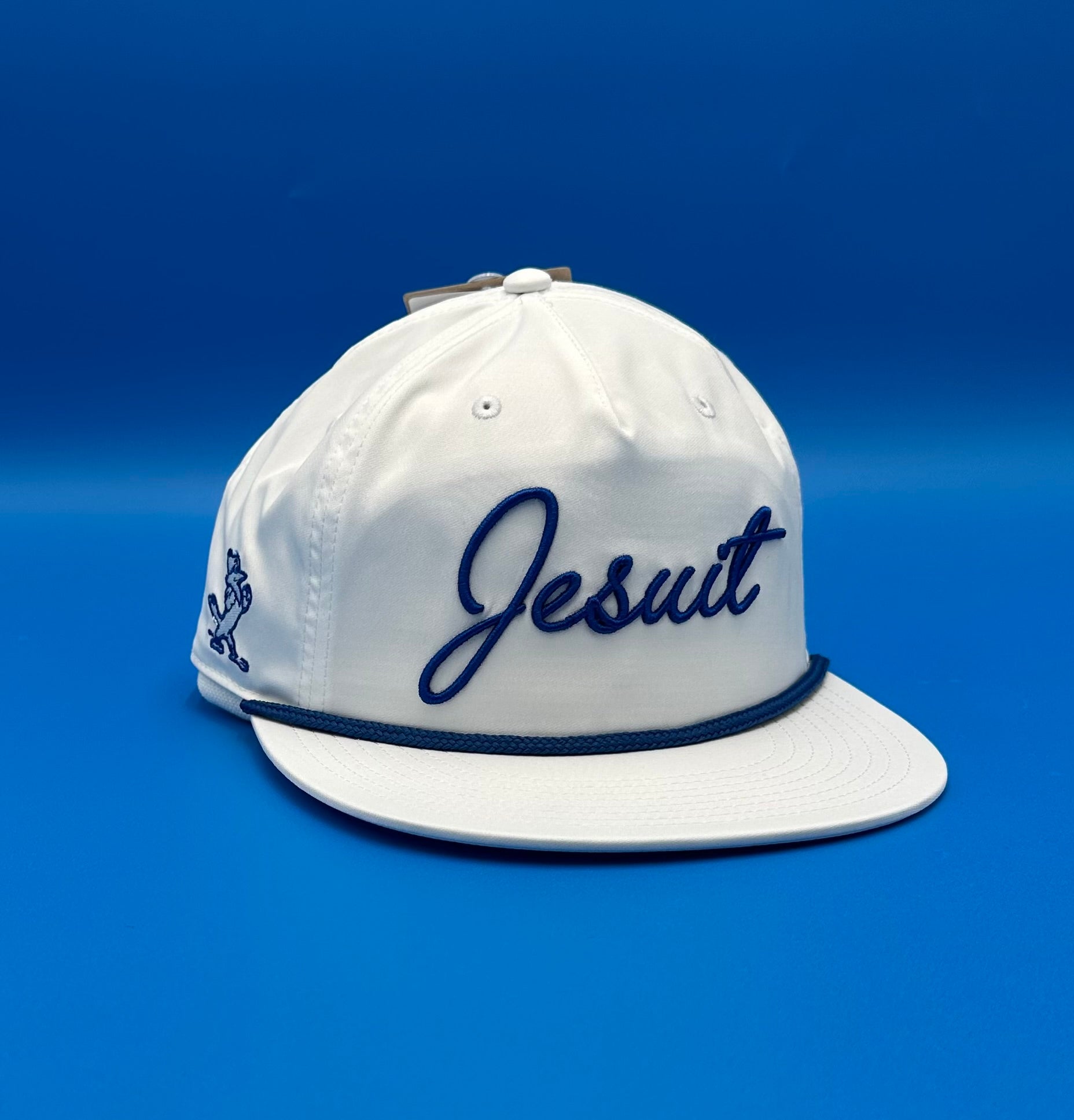 The Game.

97% Polyester/3% Spandex.&nbsp; One size fits most.

Flat bill baseball hat with performance 5-Panel gamechanger. Snapback with rope detail.

Jesuit cursive logo with Jayson logo on side.
