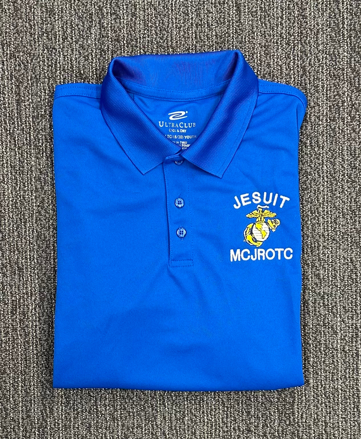 Ultra Club.

100% Polyester

Moisture-management properties. UPF 15-39 protection. Anti-bacterial. Stain-resistant.  Relaxed fit. Flat-knit collar.

MCJROTC embroidered logo.