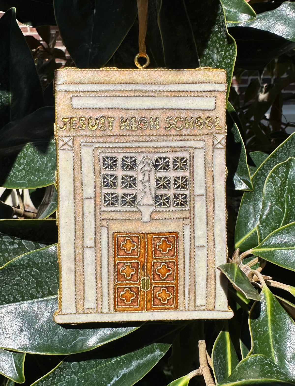 Kitty Keller Designs.

Our newest Christmas ornament to add to your collection. Celebrating 100 years of Jesuit's historic campus and its enduring mission of forming young men. In 1926, Jesuit High School boldly relocated from its longtime home on Baronne Street to the campus at Carrollton & Banks, marking the beginning of a new chapter in the school's history.

Hand-crafted cloisonne ornaments are truly one-of-a-kind. Each gold-plated wire creating the design is formed and shaped by hand.