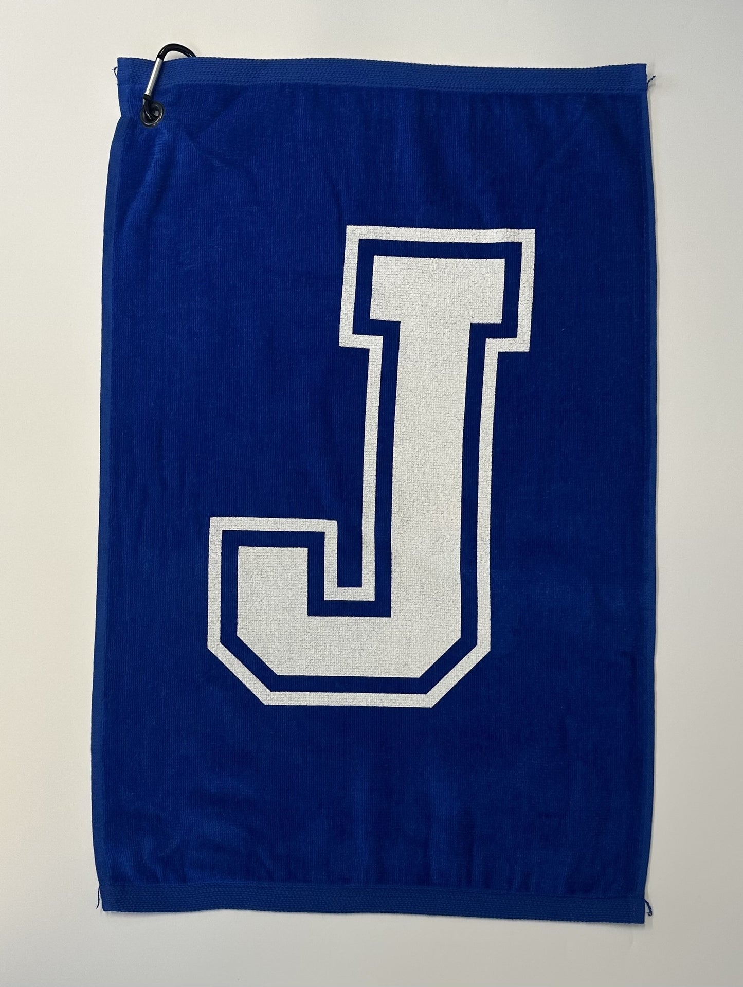 100% Cotton.  Measures 16" width x 24" length.  Solid Royal Blue with J logo.  Attached clip makes it easy to keep your towel within reach throughout your game.
