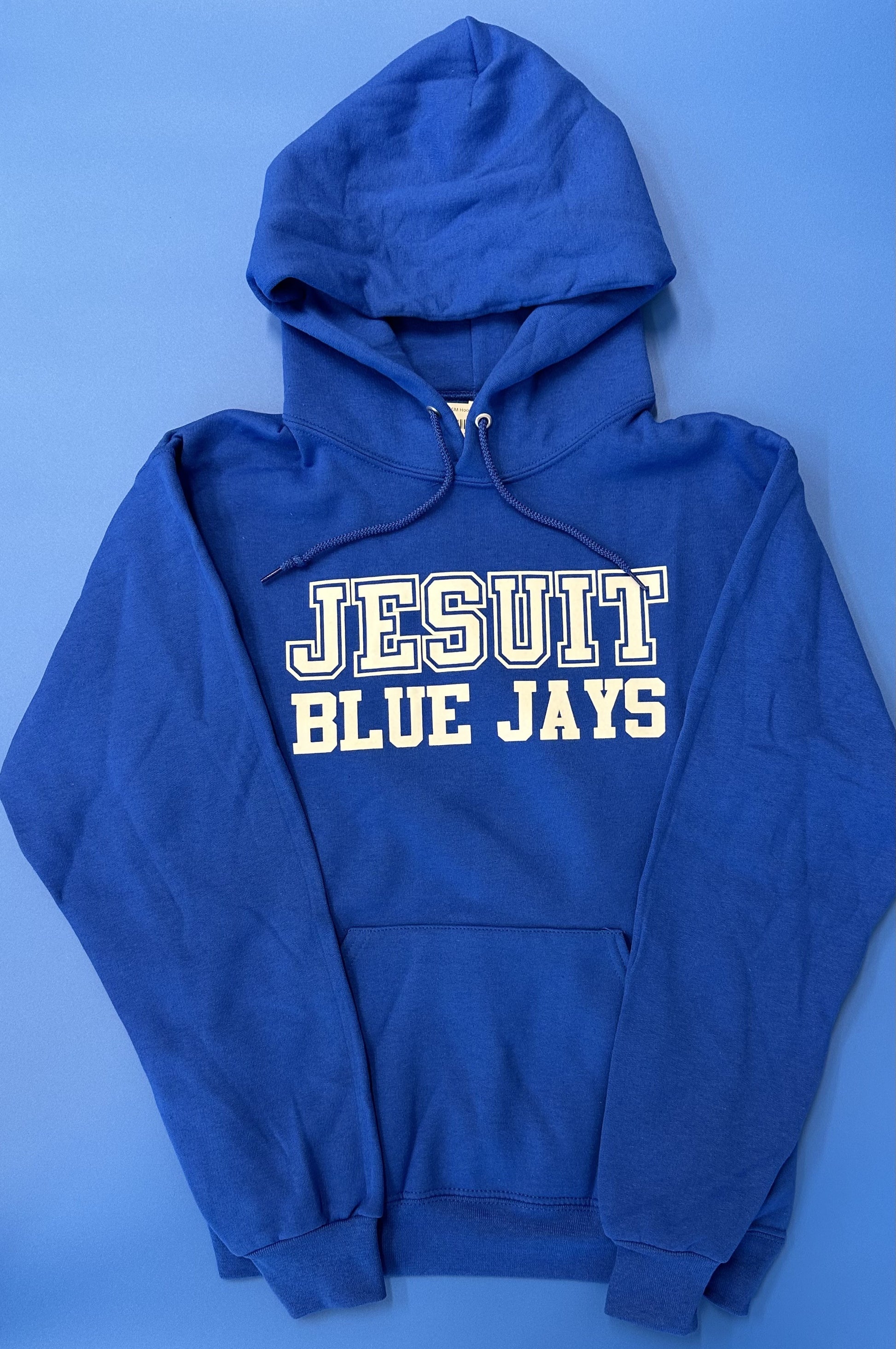 Jerzees.  50% Polyester/50% Cotton.  2 ply hood with grommets.  Front pouch pocket. 1 x 1 rib cuffs and waistband.  Screen printed Jesuit Blue Jays logo.