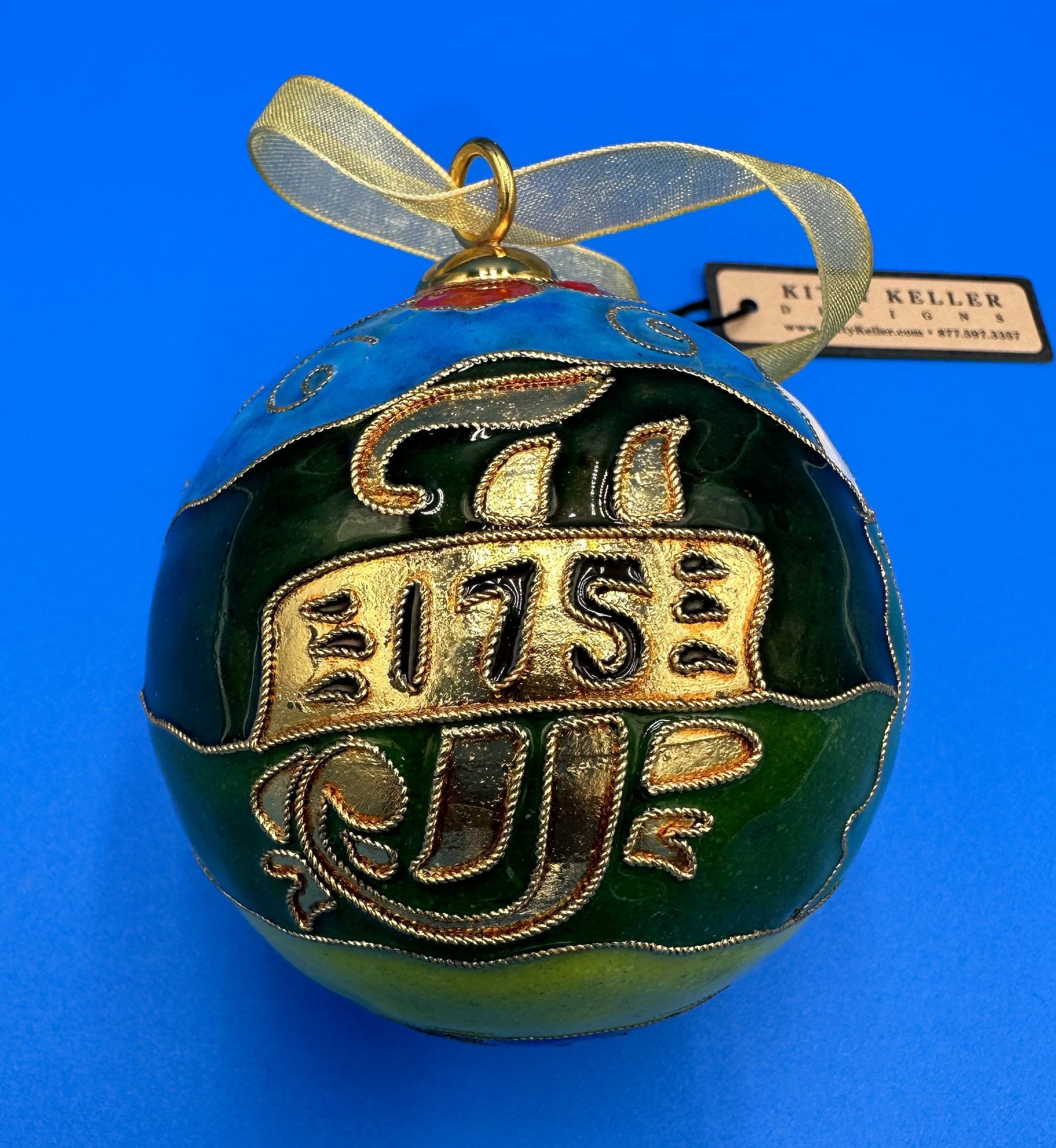 Kitty Keller Designs.  Handmade - Cloisonne' ornament.  Celebrating our 175th year in NOLA!  Features our newest building on campus:  Madonna della Strada.  Comes in a keepsake gift box.  Ornament Stand sold separately.