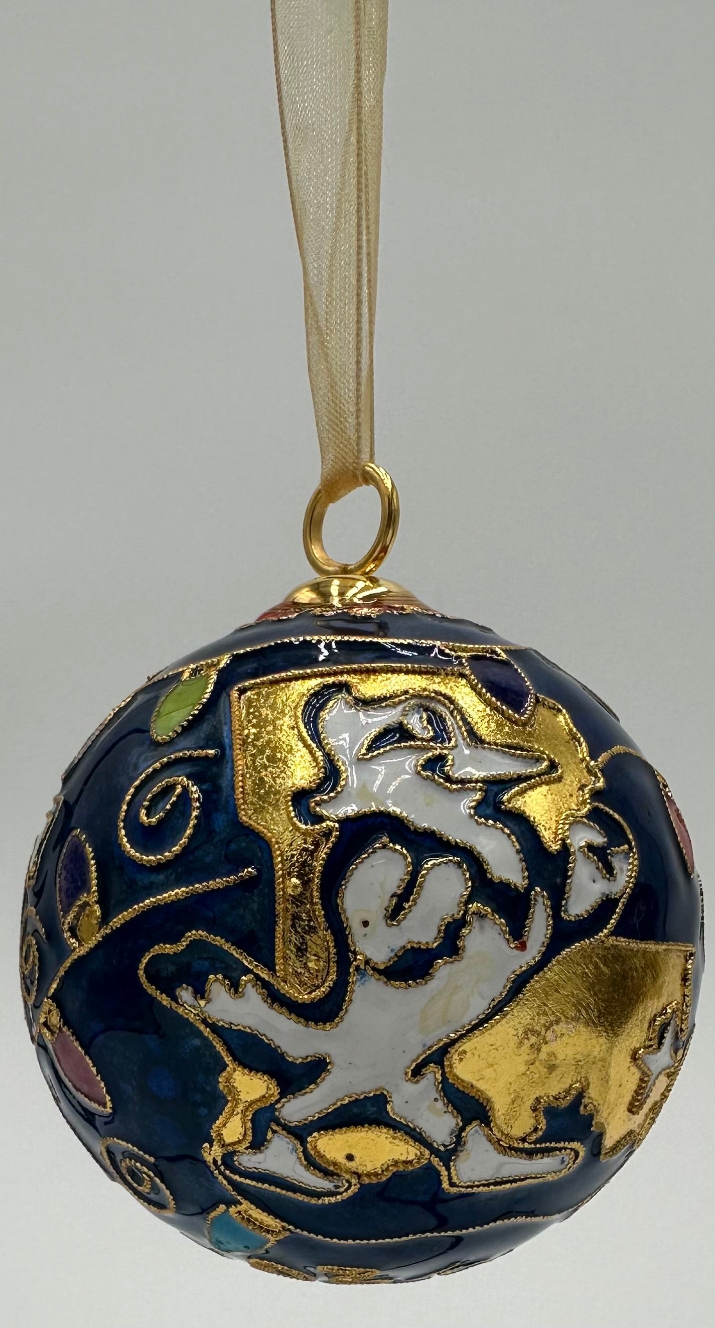 Kitty Keller Designs.

Our newest Christmas ornament to add to your collection. This year's round ornament features the JESUIT logo highlighted with festive Christmas lights and our beloved Jayson showing you exactly where we are located - NOLA!

Hand-crafted cloisonne ornaments are truly one-of-a-kind. Each gold-plated wire creating the design is formed and shaped by hand.

Comes in a silk covered gift box.