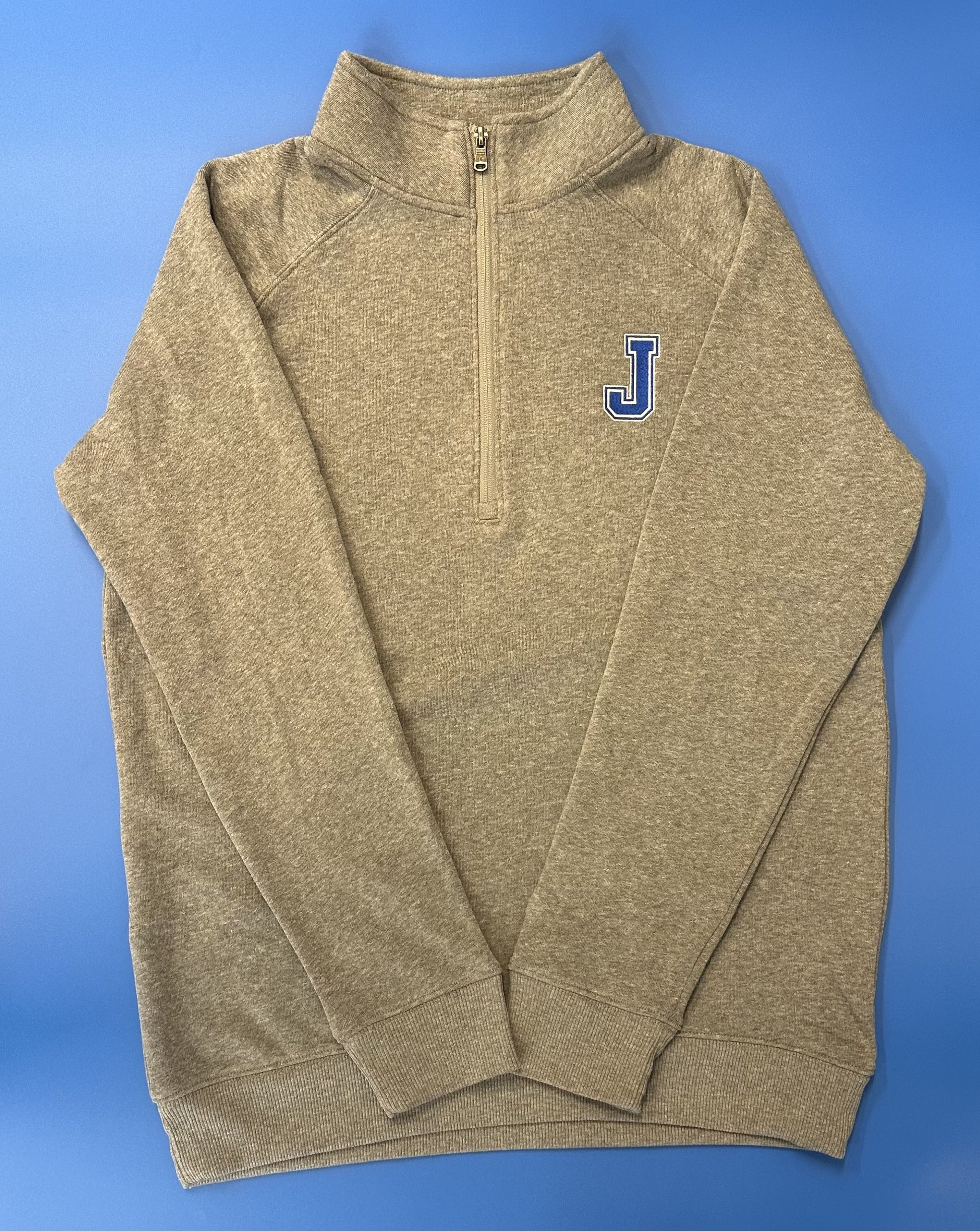 Champion.  47% polyester/39% cotton/14% rayon triblend fleece  Classic raglan silhouette with stand collar.  Color matched reverse coil zipper at center front.  2 x 2 rib at cuffs & waistband.  Embroidered J logo.