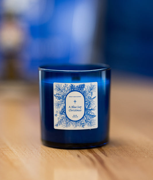 WICKS NOLA Candle Company.  Step into the holiday with our exquisite 9-ounce sapphire blue translucent jar candle with a burning time of 35-40 hours.  This holiday fragrance has a blend of eucalyptus and mint with notes of spruce, moss and evergreen.  Custom Jesuit Scent: Blue Spruce