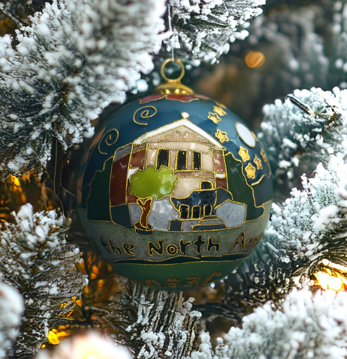 Kitty Keller Designs.

Our newest Christmas ornament to add to your collection. This year's round ornament is dedicated to The Chapel of the North American Martyrs. On their journey to become the men they were made to be, Blue Jays begin and end their education at Jesuit in the Chapel of the North American Martyrs. The chapel is the heart of student life and formation on campus.
Hand-crafted cloisonne ornaments are truly one-of-a-kind. Each gold-plated wire creating the design is formed and shaped by hand.