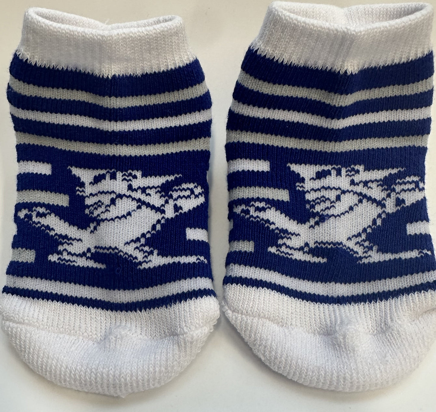 TCK Sock Collection.  97% Polyester/3% Spandex.  These booties have breathe-able construction, a form-fit band on top and a padded sole & toe-box.   Available in 2 sizes - Infant (6-18 month) & Toddler (2-4T).  Features our Fighting Blue Jay, Jayson!