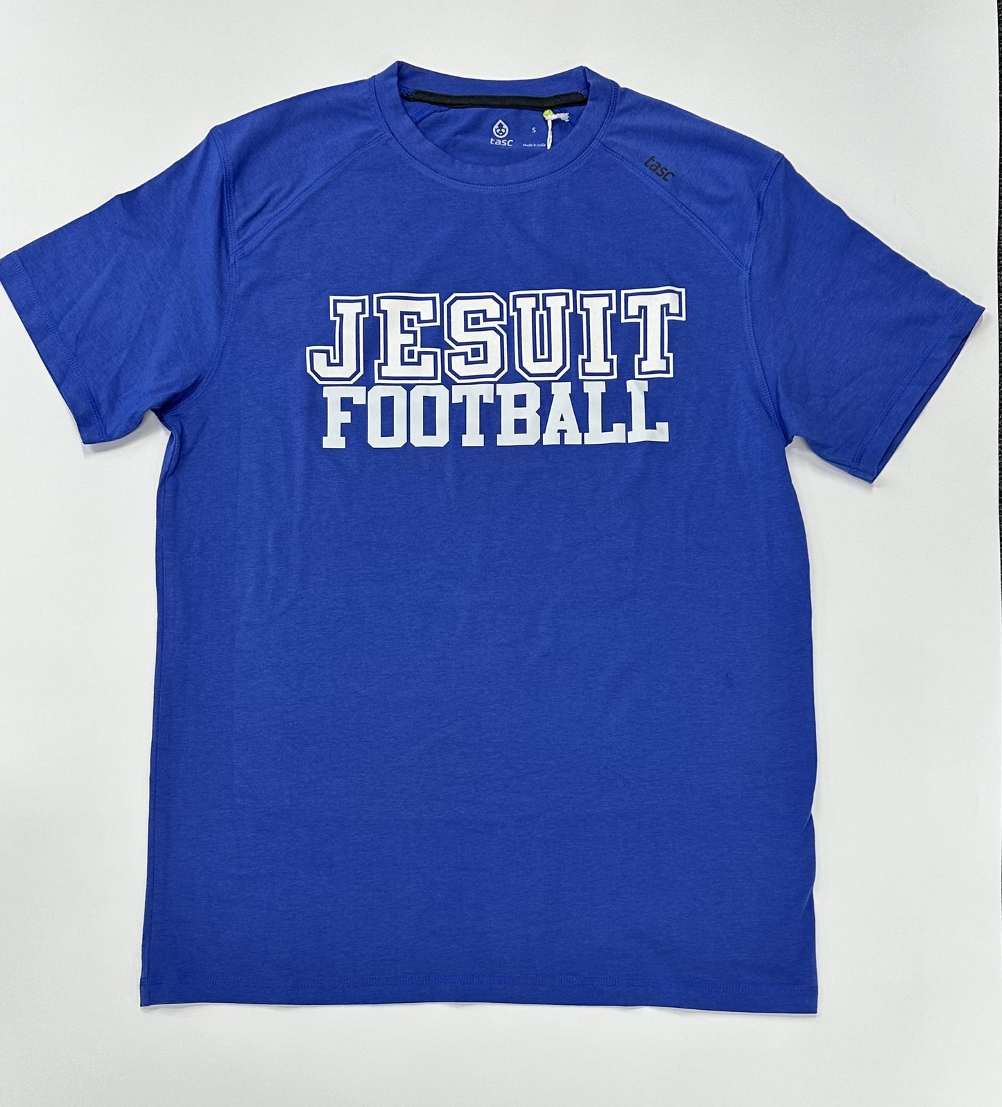 Tasc Performance.  The shirt that started this New Orleans brand!  Lightweight performance fabric for year-round comfort, modified raglan shoulder, 30" length.  52% Organic Cotton/43% Viscose from Bamboo/5% Lycra Spandex.  Jesuit FOOTBALL logo.