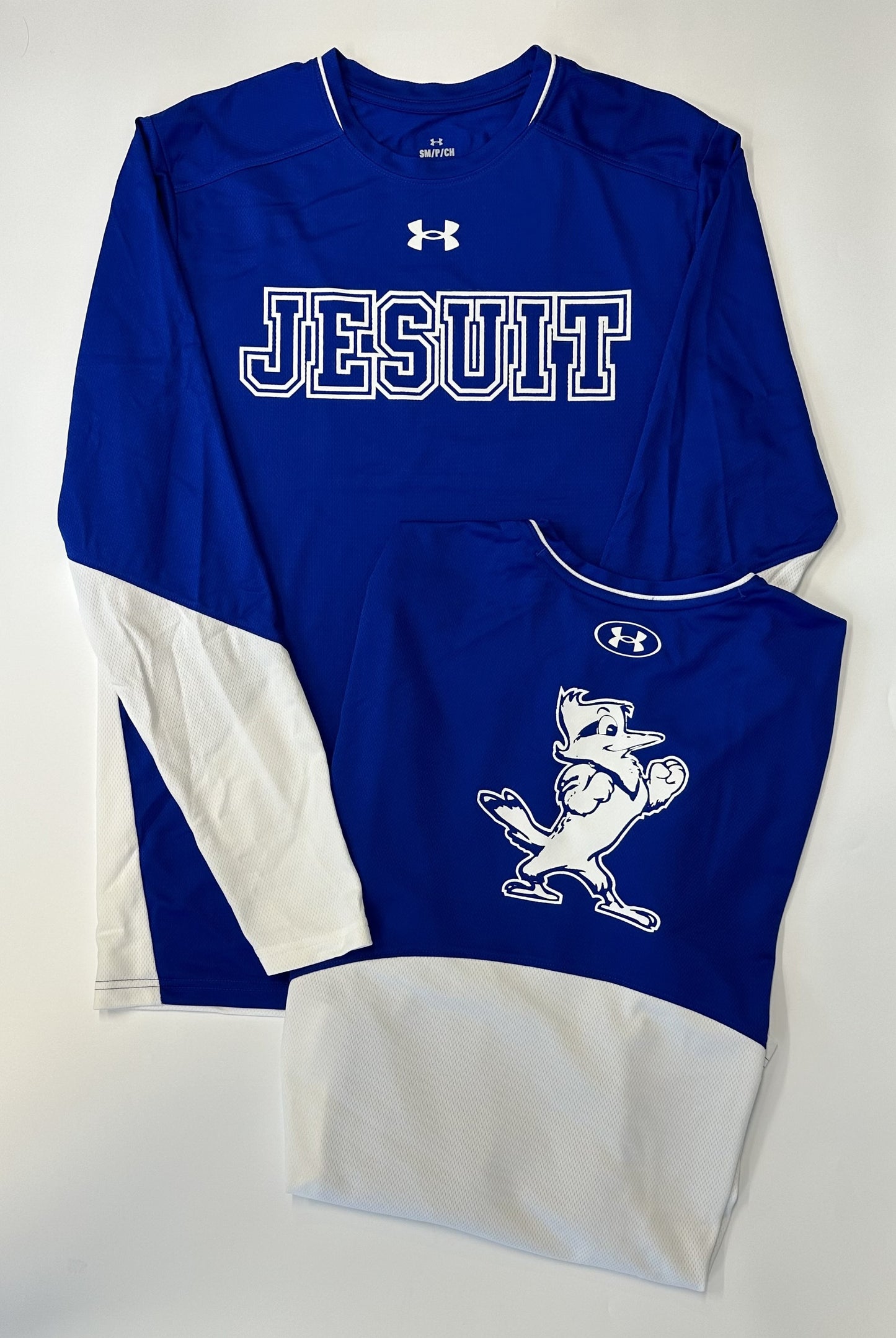 Under Armour.  100% Polyester.  UA Tech fabric is quick-drying.  Material wicks sweat & dries really fast.  Flatlock stitch and shoulder seam detail.   JESUIT logo on front with JAYSON on upper back.