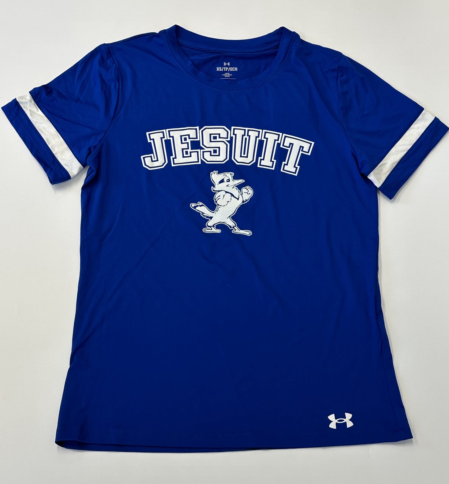 Under Armour.  90% Polyester/10% Elastane.  UA Tech fabric is quick-drying, ultra-soft & has a more natural feel. Set in sleeve construction with white blocked inset detail on sleeves.  JESUIT w/Jayson logo.
