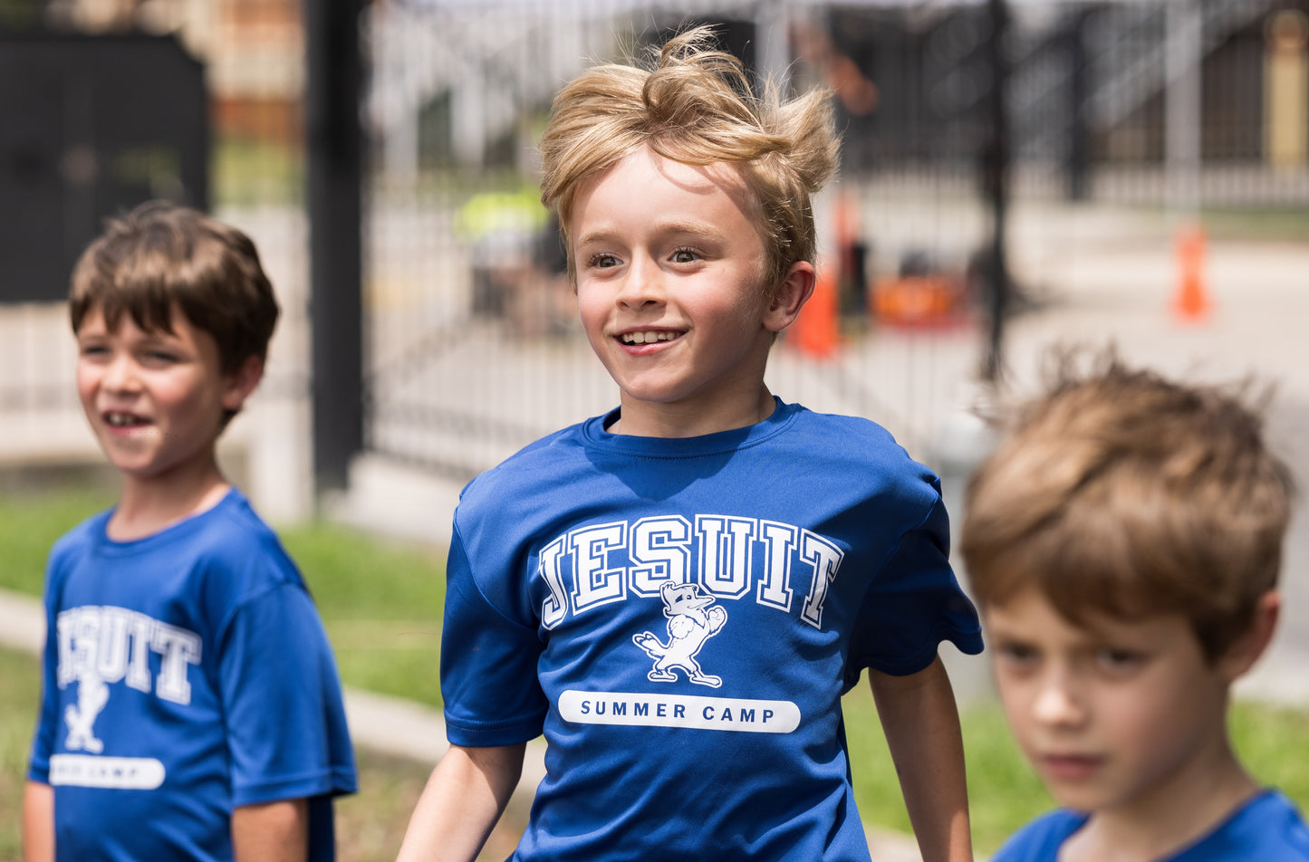 Sport-Tek.
100% polyester dry-fit.
Lightweight, roomy &amp; highly breathable. Moisture wicking. Set-in sleeves.
JESUIT summer camp logo
Blue camp shirts are worn for 
grades K-3.